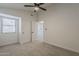 Bright bedroom with carpet, window, ceiling fan, and door to hallway at 1444 E Boston St, Chandler, AZ 85225