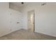 Cozy bedroom featuring neutral carpet, a walk-in closet with double doors, and an adjacent doorway at 1444 E Boston St, Chandler, AZ 85225