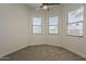 Bedroom with neutral carpet, a ceiling fan, and multiple windows with blinds for ample natural light at 1444 E Boston St, Chandler, AZ 85225