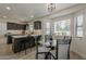 Open concept dining area with a glass table, seamlessly connects to the modern kitchen at 1444 E Boston St, Chandler, AZ 85225