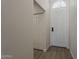 Bright foyer featuring a white front door with decorative glass and wood-look flooring at 1444 E Boston St, Chandler, AZ 85225
