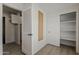 Hallway with storage spaces, including a closet and a folding table, leading to another room at 1444 E Boston St, Chandler, AZ 85225