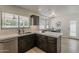 Well-lit kitchen offers stainless steel appliances, dark wood cabinets, and an open concept design at 1444 E Boston St, Chandler, AZ 85225