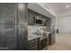 Modern kitchen featuring dark cabinets, stainless steel appliances, and white countertops at 1444 E Boston St, Chandler, AZ 85225