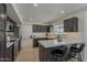 Updated kitchen with dark cabinets, modern appliances, white countertops, and breakfast bar at 1444 E Boston St, Chandler, AZ 85225