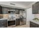 Modern kitchen features stainless steel appliances, quartz countertops, and dark wood cabinetry at 1444 E Boston St, Chandler, AZ 85225