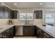 Contemporary kitchen featuring stainless appliances, white countertops, and dark cabinetry at 1444 E Boston St, Chandler, AZ 85225