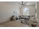 Bright living room with large window, neutral decor, and stylish ceiling fan at 1444 E Boston St, Chandler, AZ 85225
