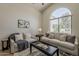 Bright living room with large arched window, neutral furniture, and modern decor at 1444 E Boston St, Chandler, AZ 85225