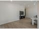 Open-concept living room with sleek media center, light wood flooring, and comfortable seating area at 1444 E Boston St, Chandler, AZ 85225