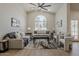 Well-lit living room featuring modern furnishings, a vaulted ceiling, and a large arched window at 1444 E Boston St, Chandler, AZ 85225