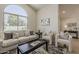 Inviting living room with neutral decor, featuring a large arched window and wood-look flooring at 1444 E Boston St, Chandler, AZ 85225