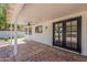 Covered patio with tiled floor and double doors creating an inviting outdoor entertaining area at 1444 E Boston St, Chandler, AZ 85225