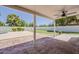 Covered patio offers a ceiling fan, shade and a view of the landscaped backyard and pool at 1444 E Boston St, Chandler, AZ 85225