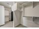 Bright walk-in closet featuring ample shelving and rack space with carpet flooring at 1444 E Boston St, Chandler, AZ 85225