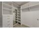 Bright walk-in closet with ample shelving, drawers, mirror, and carpet flooring at 1444 E Boston St, Chandler, AZ 85225