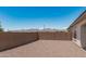 Spacious backyard with rock landscaping, privacy wall, and serene mountain views at 16981 W Cameron Dr, Surprise, AZ 85388
