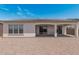 Backyard with covered patio, low-maintenance gravel landscaping, and a home exterior at 16981 W Cameron Dr, Surprise, AZ 85388