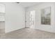Bright bedroom with neutral carpet, light walls, and an adjoining ensuite at 16981 W Cameron Dr, Surprise, AZ 85388