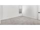 Bright bedroom featuring neutral walls, carpet, a window and a door at 16981 W Cameron Dr, Surprise, AZ 85388
