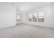 Bright, open bedroom with plush carpeting and an abundance of natural light from multiple windows at 16981 W Cameron Dr, Surprise, AZ 85388