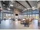 An open clubhouse area features dining tables, lounge seating, and a stone fireplace at 16981 W Cameron Dr, Surprise, AZ 85388