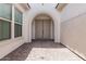 Inviting entryway with arched entry and decorative double doors, with views of the courtyard at 16981 W Cameron Dr, Surprise, AZ 85388