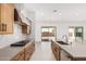 Open kitchen featuring stainless appliances, gas range, and island with seating at 16981 W Cameron Dr, Surprise, AZ 85388