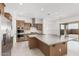 Modern kitchen with a large island, stainless steel appliances, and pendant lighting at 16981 W Cameron Dr, Surprise, AZ 85388