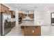 Gourmet kitchen featuring a large island, stainless steel appliances, and custom cabinetry at 16981 W Cameron Dr, Surprise, AZ 85388