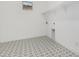 Well-lit laundry room with patterned tile flooring and convenient shelving at 16981 W Cameron Dr, Surprise, AZ 85388