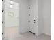 Well-lit mud room with tile floor and doorway leading to an outside area at 16981 W Cameron Dr, Surprise, AZ 85388