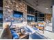 Stylish patio with fireplace, modern furniture, and floor-to-ceiling windows at 16981 W Cameron Dr, Surprise, AZ 85388