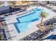 Aerial view of a luxurious community pool with ample seating and recreational facilities at 16981 W Cameron Dr, Surprise, AZ 85388