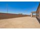 Large dirt backyard enclosed by a block wall, perfect for customization and landscaping at 17304 W Royal Palm Rd, Waddell, AZ 85355