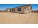 The home has a spacious dirt backyard, perfect for landscaping and outdoor activities at 17304 W Royal Palm Rd, Waddell, AZ 85355