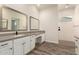 Bathroom featuring double sinks and a glass shower at 17304 W Royal Palm Rd, Waddell, AZ 85355