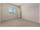 Light-filled bedroom with plush carpeting and a view of the outdoors through the window at 17304 W Royal Palm Rd, Waddell, AZ 85355