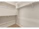 Walk-in closet is a storage solution with rods and shelves; ready to organize your items at 17304 W Royal Palm Rd, Waddell, AZ 85355