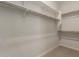 Walk-in closet offers ample storage with rods and shelves; ready to organize your wardrobe at 17304 W Royal Palm Rd, Waddell, AZ 85355