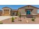 Inviting single-Gathering home features a desert landscape, neutral colors, a two car garage, and stone accents at 17304 W Royal Palm Rd, Waddell, AZ 85355