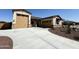 Spacious home featuring an extended driveway, desert landscaping, and tandem two-car garage at 17304 W Royal Palm Rd, Waddell, AZ 85355