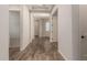 Open hallway featuring wood floors and white walls at 17304 W Royal Palm Rd, Waddell, AZ 85355