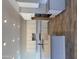 Modern kitchen boasting white cabinets, tile backsplash, island with black faucet and wood look floors at 17304 W Royal Palm Rd, Waddell, AZ 85355