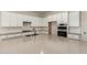 This modern kitchen offers white cabinets, a large island, and stainless steel appliances at 17304 W Royal Palm Rd, Waddell, AZ 85355