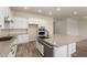 Stylish kitchen features stainless steel appliances, white cabinetry, a large island, and ample counter space at 17304 W Royal Palm Rd, Waddell, AZ 85355