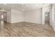 Open living room with wood-style flooring, neutral paint, a ceiling fan and access to other rooms at 17304 W Royal Palm Rd, Waddell, AZ 85355