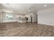 Spacious living room with wood-style flooring, recessed lighting, and plenty of room to gather with Gathering at 17304 W Royal Palm Rd, Waddell, AZ 85355