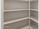 A walk-in pantry with adjustable white shelves at 17304 W Royal Palm Rd, Waddell, AZ 85355