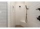 Shower with white subway tile and black fixtures at 17304 W Royal Palm Rd, Waddell, AZ 85355